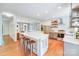 Modern kitchen featuring a large island with seating, stainless steel appliances, and hardwood floors at 10338 Hollybrook Dr, Charlotte, NC 28277