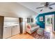 Laundry area and bonus room with hardwood floors and blue accent wall at 10338 Hollybrook Dr, Charlotte, NC 28277