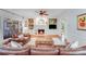 Inviting living room features built-in bookshelves, a fireplace, and comfortable leather seating at 10338 Hollybrook Dr, Charlotte, NC 28277