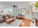 Cozy living room features a fireplace, a leather sofa, and an open layout leading to the kitchen at 10338 Hollybrook Dr, Charlotte, NC 28277