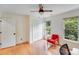 Sunny office with wooden floors, large windows, red chair and modern office setup at 10338 Hollybrook Dr, Charlotte, NC 28277