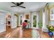 Bright office space featuring hardwood floors, a standing desk, and views of the landscaped yard at 10338 Hollybrook Dr, Charlotte, NC 28277