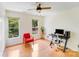 Bright room with wooden floors, large windows and modern office setup at 10338 Hollybrook Dr, Charlotte, NC 28277