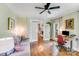Comfortable office with hardwood floors, a sofa, a modern desk, and glass doors leading to another room at 10338 Hollybrook Dr, Charlotte, NC 28277