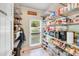 Well-organized pantry with ample shelving, storage for food items, and a window for natural light at 10338 Hollybrook Dr, Charlotte, NC 28277