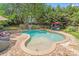 Private in-ground pool and spa surrounded by a brick patio and lush landscaping at 10338 Hollybrook Dr, Charlotte, NC 28277
