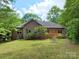 Brick home with a wood deck and well-maintained lawn, perfect for outdoor gatherings with a table and chair set at 1061 Nw 14Th Avenue Nw Dr, Hickory, NC 28601