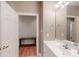 Bathroom featuring white vanity, sink, and a doorway leading to a room with hardwood floors at 1061 Nw 14Th Avenue Nw Dr, Hickory, NC 28601