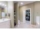 Bathroom showcasing a white vanity, storage shelves, a toilet, and a door to a walk-in closet at 1061 Nw 14Th Avenue Nw Dr, Hickory, NC 28601