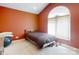 Cozy bedroom featuring carpet floors, a single bed and natural light streaming through the arched window at 1061 Nw 14Th Avenue Nw Dr, Hickory, NC 28601
