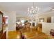 Open-concept dining area with a chandelier, wooden table, and seamless flow to the living room at 1061 Nw 14Th Avenue Nw Dr, Hickory, NC 28601
