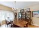 Elegant dining room with a chandelier, large window, and classic wooden furniture at 1061 Nw 14Th Avenue Nw Dr, Hickory, NC 28601