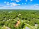 An aerial view showing the home's location in a lush, green neighborhood with mature trees and landscaping at 107 Blue Ridge Trl, Mooresville, NC 28117