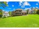 Aerial view of the house from the backyard and large manicured lawn, brick house, and forest at 107 Blue Ridge Trl, Mooresville, NC 28117