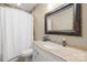 Bathroom with a decorative mirror and a marble sink and countertop next to a toilet and curtained shower at 107 Blue Ridge Trl, Mooresville, NC 28117