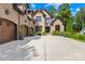 Charming front view of a brick home with an attached three-car garage and beautifully landscaped grounds at 107 Blue Ridge Trl, Mooresville, NC 28117