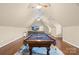 Well-lit game room with a pool table and a sectional sofa, perfect for recreation and relaxation at 107 Blue Ridge Trl, Mooresville, NC 28117