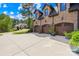 Three-car garage of a brick home featuring well-maintained landscaping and a large driveway at 107 Blue Ridge Trl, Mooresville, NC 28117