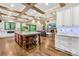 Elegant kitchen with an island bar top, hardwood floors, and a view of the living room at 107 Blue Ridge Trl, Mooresville, NC 28117