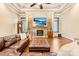 Living room with a stone fireplace and a large TV, enhanced by comfortable seating and natural light at 107 Blue Ridge Trl, Mooresville, NC 28117