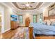 Bright main bedroom featuring trey ceiling with ceiling fan, hardwood floors, and plenty of natural light at 107 Blue Ridge Trl, Mooresville, NC 28117