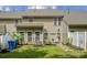 Back exterior view of home with patio, fenced yard and greenery at 108 N Arcadian Way, Mooresville, NC 28117