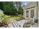 Backyard patio with a striped outdoor rug, seating, and lush greenery at 108 N Arcadian Way, Mooresville, NC 28117
