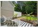 Backyard patio with a striped outdoor rug, seating, and greenery at 108 N Arcadian Way, Mooresville, NC 28117