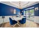 Cozy dining room with blue walls, gold accents, and bright natural light at 108 N Arcadian Way, Mooresville, NC 28117