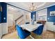 Dining area with adjacent staircase features blue walls and view into kitchen at 108 N Arcadian Way, Mooresville, NC 28117