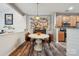 Eat-in kitchen dining area with wood floors and vintage-style decor at 108 N Arcadian Way, Mooresville, NC 28117