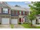 Charming brick townhome with a well-manicured lawn, attached garage, and a lovely front entrance at 108 N Arcadian Way, Mooresville, NC 28117