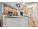 Open kitchen with wood cabinets, stainless appliances, and view into the dining room at 108 N Arcadian Way, Mooresville, NC 28117
