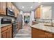 Kitchen with stainless steel appliances and view into dining room at 108 N Arcadian Way, Mooresville, NC 28117