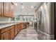 Bright kitchen featuring wood cabinets, stainless steel appliances and view to dining area at 108 N Arcadian Way, Mooresville, NC 28117