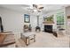 Comfortable living room with a fireplace, ceiling fan, and abundant natural light at 108 N Arcadian Way, Mooresville, NC 28117