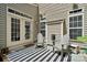Cozy patio with a striped outdoor rug, seating, and natural light at 108 N Arcadian Way, Mooresville, NC 28117