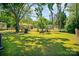 Expansive backyard with lush green grass and a vintage brick fire pit, ideal for outdoor fun at 1111 Green Street Ext, Rock Hill, SC 29730