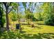 Wide-open backyard offers plenty of space, shaded by mature trees, perfect for outdoor enjoyment at 1111 Green Street Ext, Rock Hill, SC 29730
