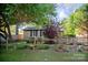 Charming brick home featuring a cozy front yard with mature trees and quaint rustic accents at 1111 Green Street Ext, Rock Hill, SC 29730