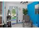 Small living room features blue accent wall and a recliner near the window with patterned curtains at 1111 Green Street Ext, Rock Hill, SC 29730