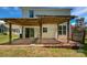 Backyard patio covered by a wooden pergola, offering a relaxed outdoor living space with brick retaining wall at 1184 Lempster Nw Dr, Concord, NC 28027