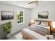 Bright staged bedroom with modern decor, a comfortable bed, and ample natural light from a large window at 1184 Lempster Nw Dr, Concord, NC 28027