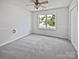 Bedroom featuring plush carpeting, a ceiling fan, and a bright window at 1184 Lempster Nw Dr, Concord, NC 28027