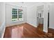 Elegant dining room featuring hardwood floors, wainscoting, a large window, and modern lighting at 1184 Lempster Nw Dr, Concord, NC 28027