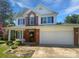 Charming two-story home featuring a two-car garage, complemented by a well-manicured lawn and beautiful landscaping at 1184 Lempster Nw Dr, Concord, NC 28027