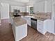 Bright kitchen featuring white cabinets, granite countertops, stainless steel appliances, and a functional center island at 1184 Lempster Nw Dr, Concord, NC 28027