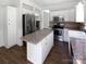 Kitchen with island, stainless appliances, granite countertops, and lots of cabinet space at 1184 Lempster Nw Dr, Concord, NC 28027