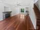 Spacious living room featuring gleaming hardwood floors, a stone fireplace, and an abundance of natural light at 1184 Lempster Nw Dr, Concord, NC 28027