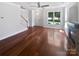 Bright living room with hardwood floors, fireplace, and large window providing ample natural light at 1184 Lempster Nw Dr, Concord, NC 28027